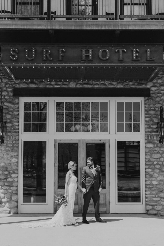 Bride and groom walk outside of the Surf Hotel in Buena Vista