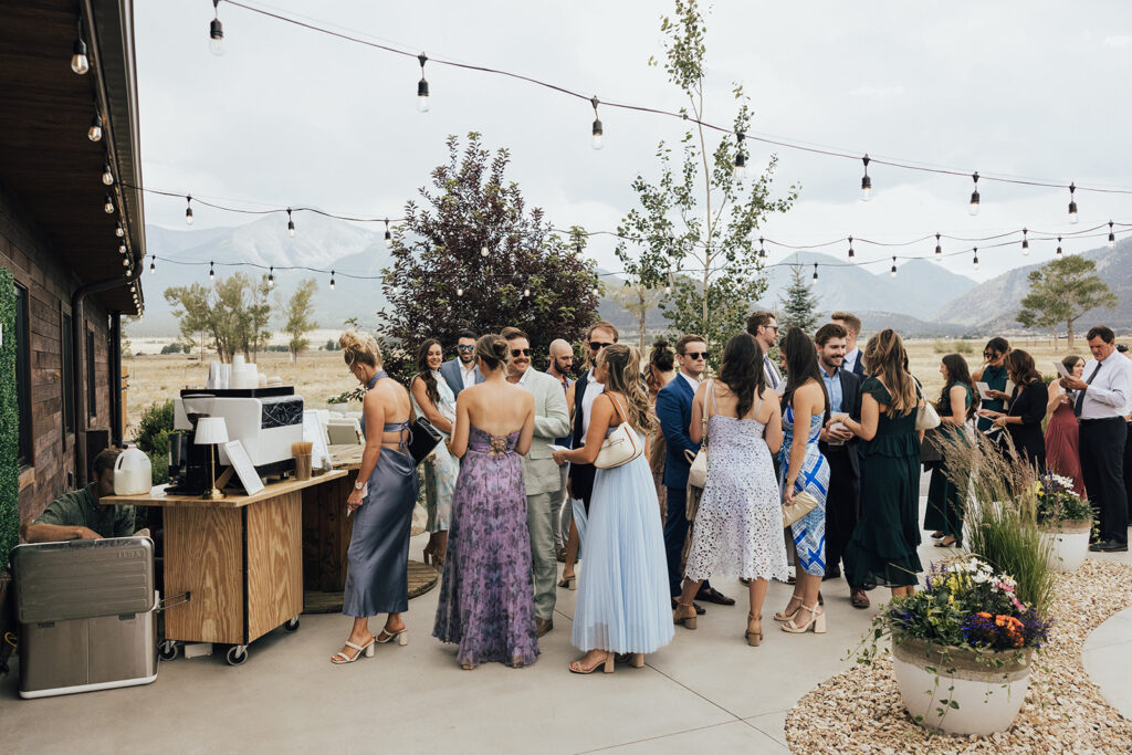 Wedding guests gather around the coffee bar before a Barn wedding ceremony in Colorado