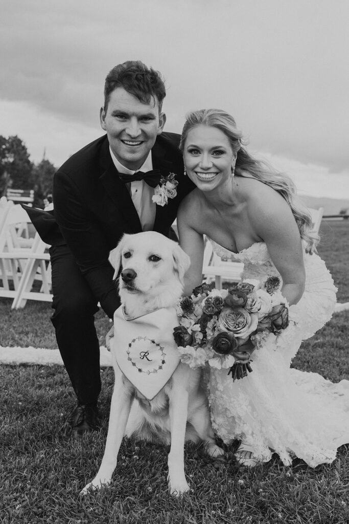 Bride and groom take photo with their dog after ceremony