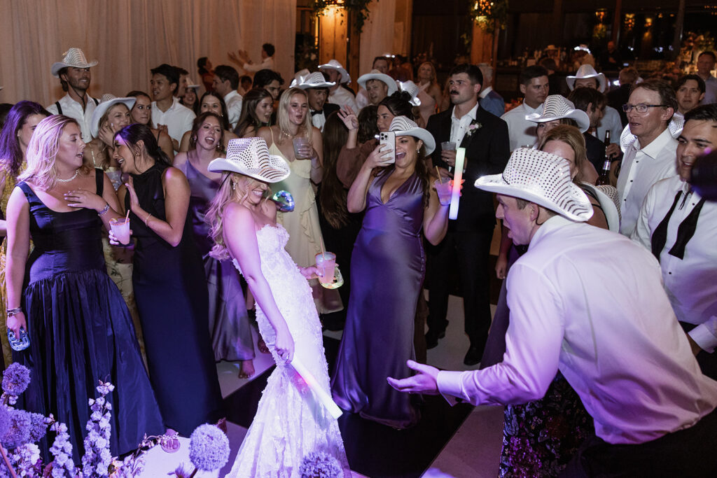 A packed wedding reception dance floor with live band