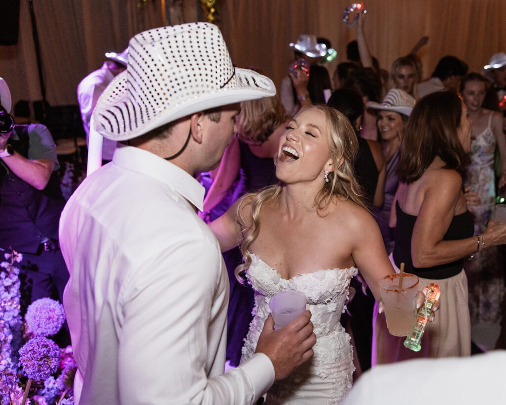 A packed wedding reception dance floor with live band