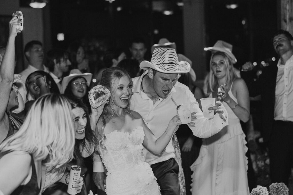 A packed wedding reception dance floor with live band