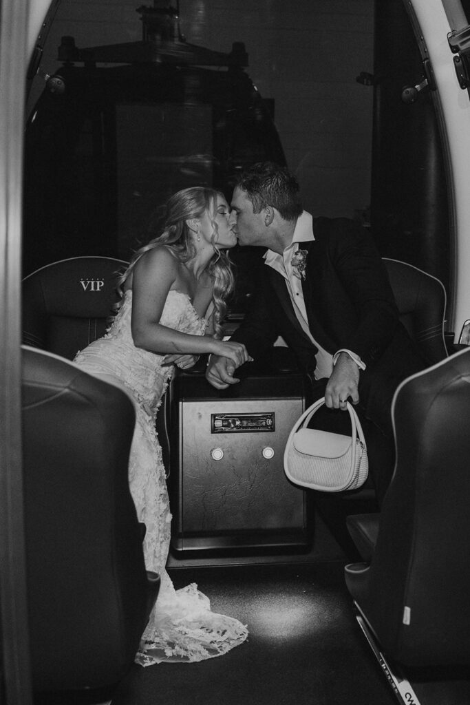Bride and groom ride down the mountain by gondola after wedding day