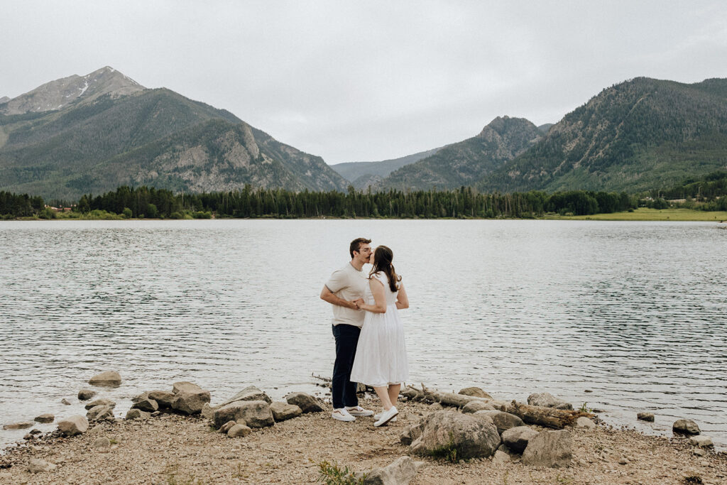 Alpine Lake engagement session in Colorado with mountains in the backdrop