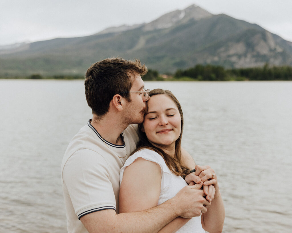 Alpine Lake engagement session in Colorado with mountains in the backdrop