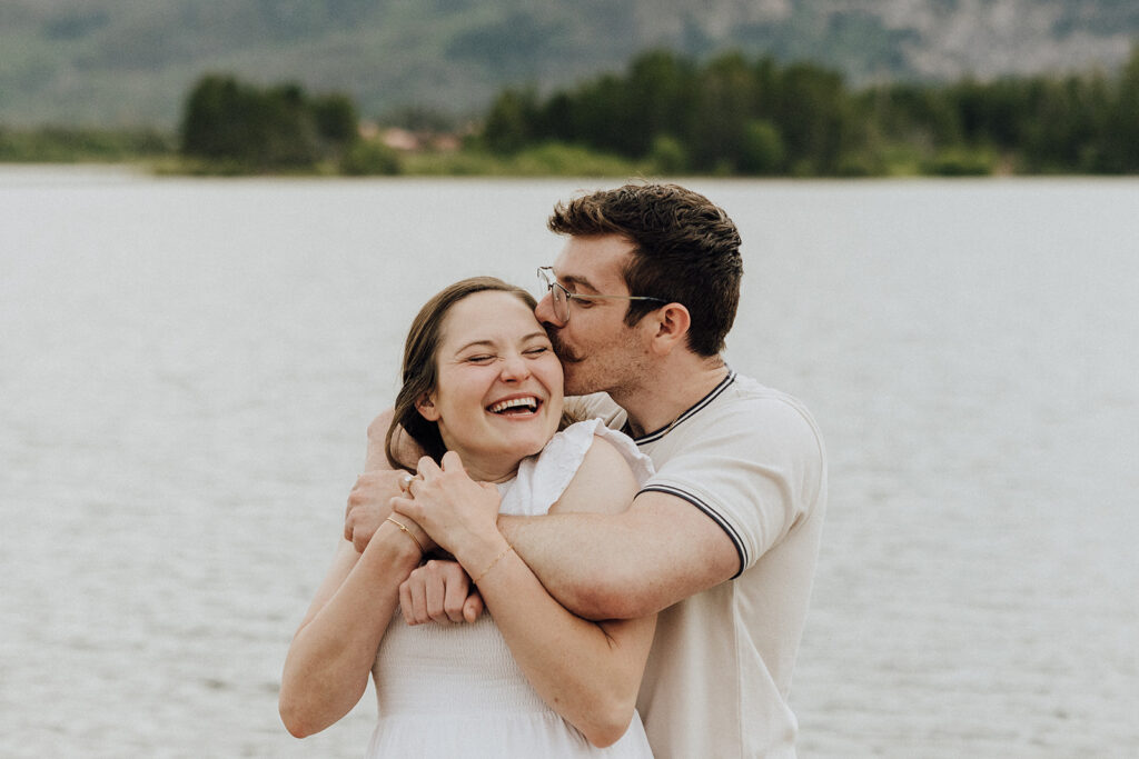 Alpine Lake engagement session in Colorado with mountains in the backdrop