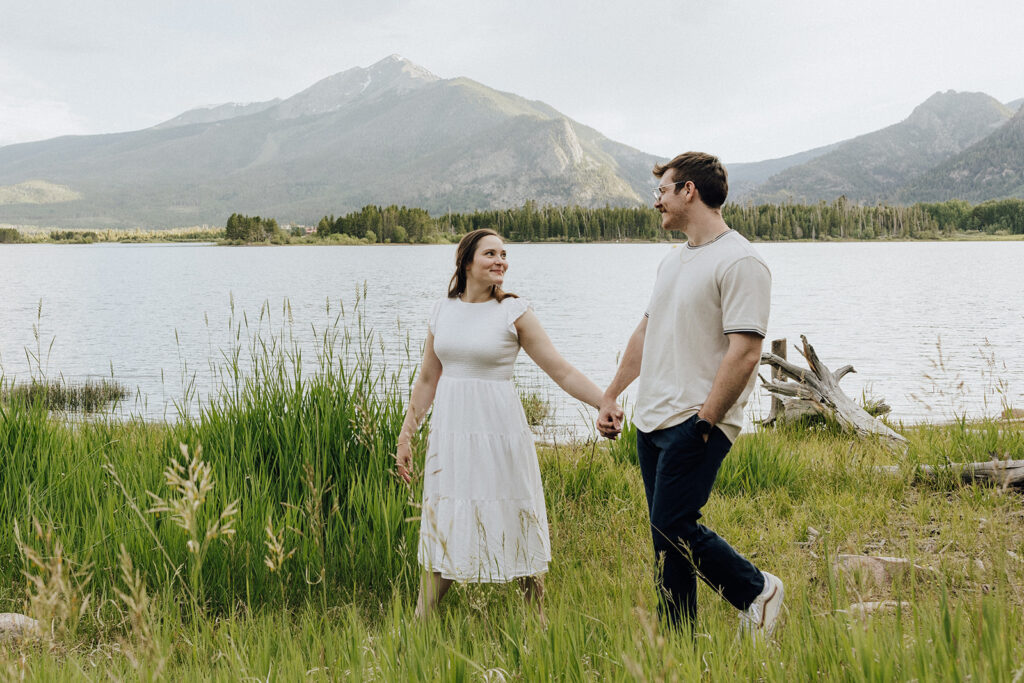 Alpine Lake engagement session in Colorado with mountains in the backdrop