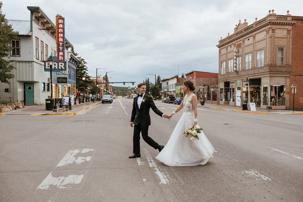 Bride and groom walk the streets of Leadville for some portraits after their FREIGHT wedding ceremony