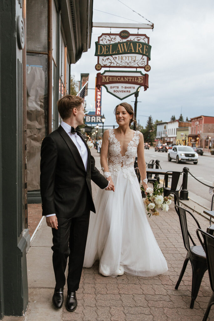 Bride and groom walk the streets of Leadville for some portraits after their FREIGHT wedding ceremony