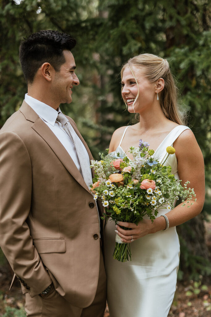 Colorado wedding photos in the woods with wildflower bouquet